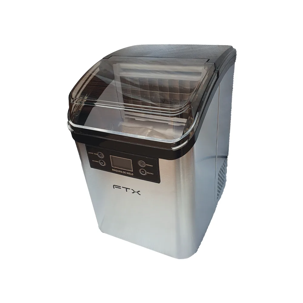 Fabricadora de hielo FTX compacta plateada, con tapa superior transparente ahumada, panel frontal con pantalla y botones y rejillas laterales de ventilación.
