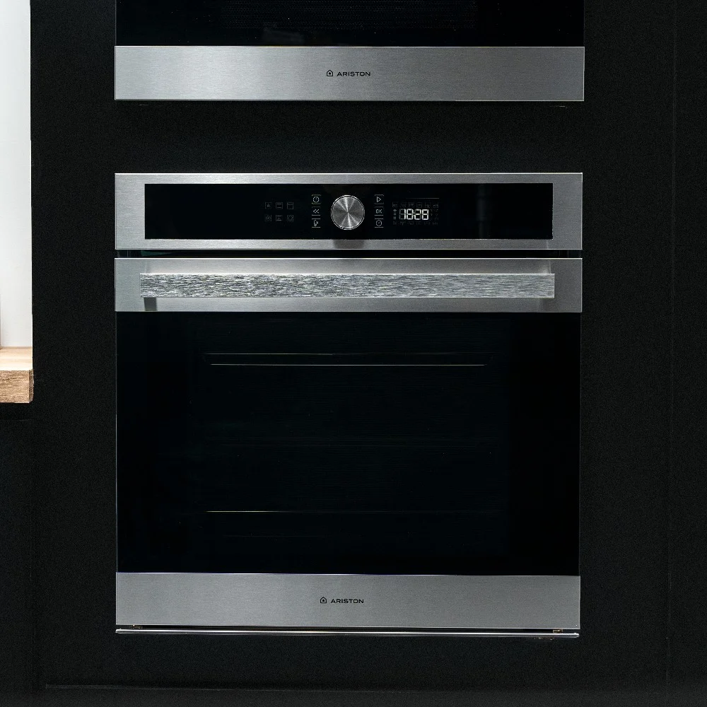 Horno empotrable Ariston plateado con panel digital negro, mando central y puerta de vidrio oscuro. - Vista 2