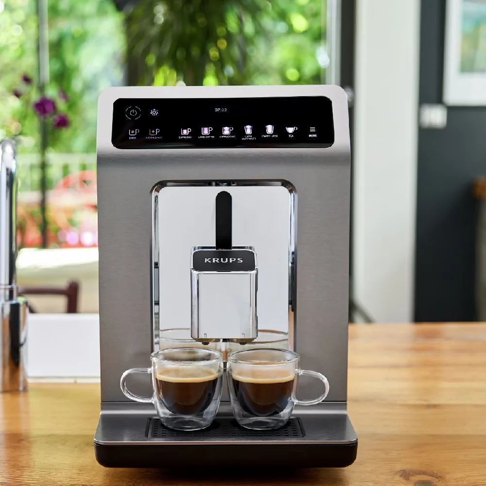 Cafetera automática Krups Evidence de acabado plateado, con panel negro, pantalla central, controles táctiles y salida frontal ajustable. - Vista 3