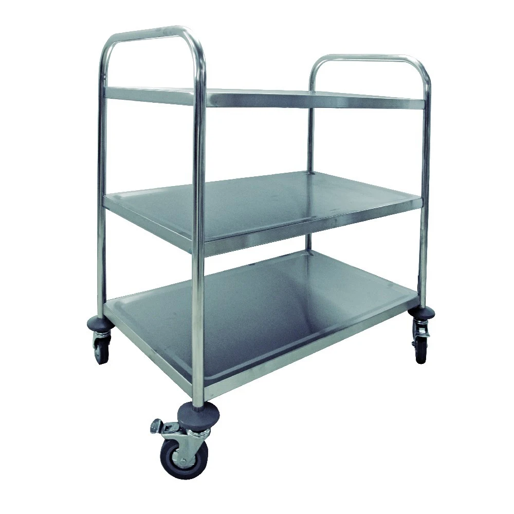 Carro metálico plateado con estructura tubular, asas, bandejas de bordes elevados y ruedas giratorias; la imagen muestra dos bandejas.