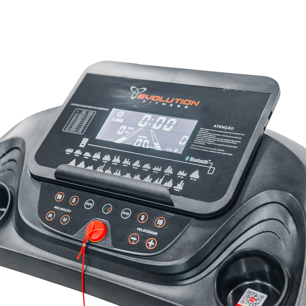 Caminadora Evolution EVO 3100 negra, con consola inclinada, pantalla, pasamanos y detalles naranjas en la plataforma. - Vista 2